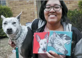  ?? PHOTOS BY LMOTERO— THE ASSOCIATED PRESS ?? Danielle Moore poses for photos with Kana and also paintings of the pet Australian cattle dog in Dallas. In the dog-eat-dog world of online shopping, Chewy has an unusual plan to fend off Amazon: turning pets into works of art. The online pet shop surprises customers with oil paintings of their furry friends, a move the company says wins them customers for life.