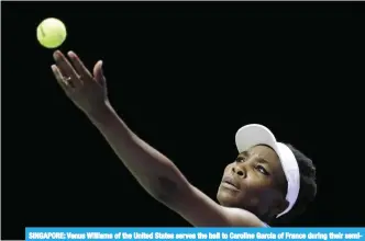  ??  ?? SINGAPORE: Venus Williams of the United States serves the ball to Caroline Garcia of France during their semifinal match at the WTA tennis tournament in Singapore. — AP