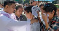  ?? AFP ?? A priest blesses one of the relatives of victims of extra-judicial killings in President Rodrigo Duterte’s drug war during a gathering on the grounds of a church in Manila on Wednesday. —