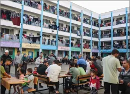  ?? SAMAR ABU ELOUF — THE NEW YORK TIMES ?? People shelter at a school affiliated with the United Nations Relief and Works Agency (UNRWA) in Khan Younis, in the southern Gaza Strip, on Oct. 19, 2023.