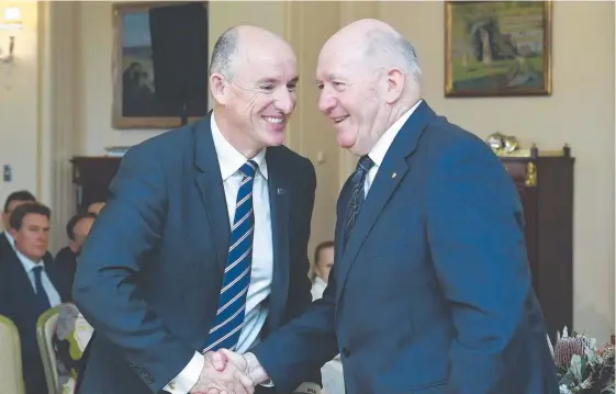  ?? Picture: AAP IMAGE ?? Governor-General Sir Peter Cosgrove (right) shakes hands with National Disability Insurance Scheme Minister Stuart Robert at the swearing-in.