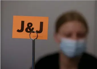  ?? NAncy lAne / HerAld STAff file ?? WAIT! Signs for the Johnson & Johnson COVID-19 vaccine sit on tables as Tufts Medical Center personnel get ready to administer shots on March 4.