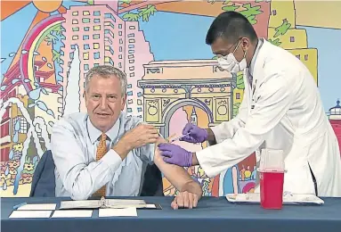  ?? THE ASSOCIATED PRESS FILE PHOTO ?? Will older Canadians be getting booster shots? New York Mayor Bill de Blasio, left, receives a COVID-19 Moderna vaccine booster from New York City Health Commission­er Dr. Dave Chokshi.