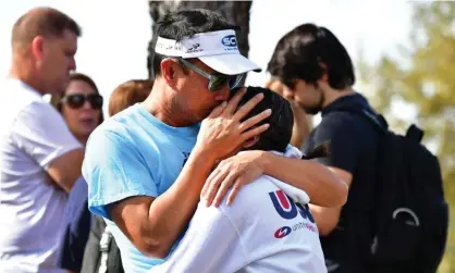  ?? Photograph: Frederic J Brown/AFP via Getty Images ?? Students are reunited with their parents in Santa Clarita, California, after a shooting that killed two and wounded three.