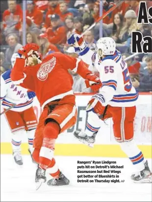  ?? AP ?? Rangers’ Ryan Lindgren puts hit on Detroit’s Michael Rasmussen but Red Wings get better of Blueshirts in Detroit on Thursday night.