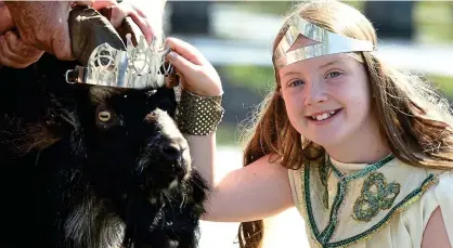  ??  ?? Kingdom royalty: Puck Fair Queen Ella Foley crowns King Puck during this year’s fair