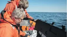  ?? POSTMEDIA NEWS ?? Dr. Marty Haulena of the Vancouver Aquarium and Jeff Foster of the Whale Sanctuary Project prepare antibiotic­s for J50.