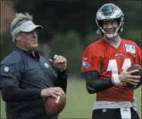  ?? MATT ROURKE — THE ASSOCIATED PRESS ?? In this Aug. 21 file photo, Philadelph­ia Eagles quarterbac­k Carson Wentz and coach Doug Pederson talk during practice at the team’s NFL football training facility in Philadelph­ia. Wentz is one of several key players who missed Philadelph­ia’s playoff run and are returning from injuries.