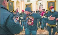  ?? MANUEL BALCE CENETA/AP PHOTO ?? Trump supporters confront U.S. Capitol Police Jan. 6 in the hallway outside of the Senate chamber at the Capitol in Washington.