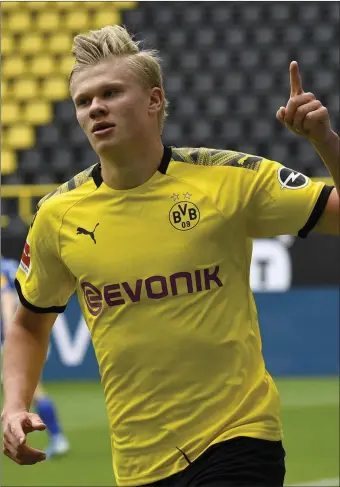  ??  ?? Erling Haaland celebrates in front of empty stands after scoring for Borussia Dortmund in their 4-0 win over Schalke on Saturday.