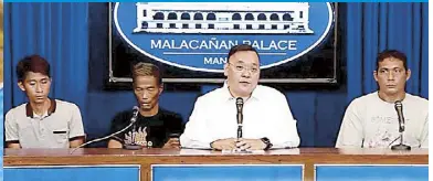  ?? EPA-EFE ?? An activist holds a placard during a protest at the Chinese consulate in Makati yesterday. Above, RTVM screen grab shows presidenti­al spokesman Harry Roque with three fishermen who claimed the Chinese coast guard has been seizing part of their fish catch around Panatag Shoal.