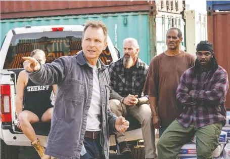  ?? CBS ?? Tough as Nails creator and host Phil Keoghan offers some advice to a handful of the new reality show’s dozen competitor­s.