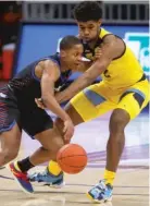  ?? MICHAEL WITTLIFF/MARQUETTE ATHLETICS ?? DePaul guard Charlie Moore looks to drive around Marquette forward Justin Lewis on Saturday.