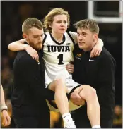  ?? CLIFF JETTE — THE ASSOCIATED PRESS ?? Iowa guard Molly Davis (1) is carried off the court after injuring her right knee against Ohio State last Sunday. She’s expected to return to action.