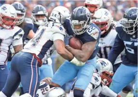  ?? GEORGE ?? Titans running back Derrick Henry (22) is stopped by the Patriots defense in the second half at Nissan Stadium Sunday, Nov. 11, 2018, in Nashville, Tenn. WALKER IV / TENNESSEAN.COM