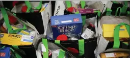  ?? JOHN MINCHILLO — THE ASSOCIATED PRESS ?? Free groceries are packed for distributi­on to the elderly at Hope Community Services in New Rochelle, New York, an area where the coronaviru­s has hit hard.