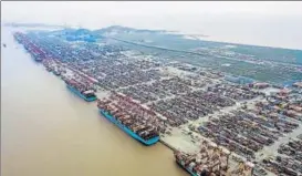  ?? BLOOMBERG ?? Container ships docked at the Yangshan Deepwater Port in Shanghai, China.