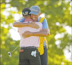  ?? Matt York The Associated Press ?? Justin Thomas celebrates with his caddie, Jim “Bones” Mackay, after winning the PGA Championsh­ip at Southern Hills on Sunday.