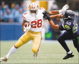  ?? OTTO GREULE JR. - GETTY IMAGES ?? Running back Carlos Hyde got by K.J. Wright and the Seahawks and gained 124 yards but with no touchdowns.