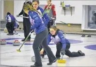  ?? ERIC MCCARTHY/ JOURNAL PIONEER ?? Sweepers Rachel O’Connor, left, and Breanne Burgoyne take charge of a stone just released by their skip, Lauren Lenentine. Team Lenentine enters the Pepsi P. E. I. provincial junior women’s triple knock- out curling championsh­ip at the Maple Leaf...