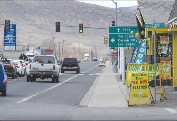  ?? SCOTT SONNER / ASSOCIATED PRESS FILE (2021) ?? Traffic passes on Main Street in Fernley, which was founded a century ago by pioneers lured to the West with the promise of free land and cheap water. It wasn’t incorporat­ed as a city until 2001, though.