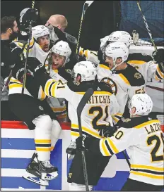  ?? — BRAD MILLS/USA TODAY SPORTS ?? Boston's Brad Marchand, left, jumps into his team's bench after scoring the overtime goal on Monday to give his team a 4-3 win over the Capitals in Washington.