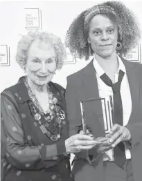  ?? SIMON DAWSON/REUTERS ?? Margaret Atwood poses with Bernardine Evaristo with their Booker Prize for Fiction 2019 at the Guildhall in London, Monday.