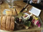  ?? BETH J. HARPAZ — THE ASSOCIATED PRESS ?? This photo shows bread, olives and other pre-dinner nibbles served at The Lost Kitchen in Freedom, Maine, before the meal begins.