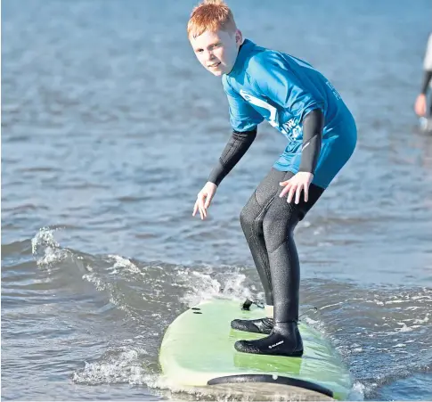  ??  ?? UP FOR IT: St Andrews University students have raised cash to set up a surf therapy project at West Sands.