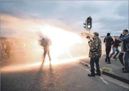  ??  ?? Shutdown: Mass action on the Cape Flats on Tuesday invoked the spirit of resistance residents remember from the 1990s and the apartheid years, as did the police’s response, which included teargas and arrests. Photos: David Harrison