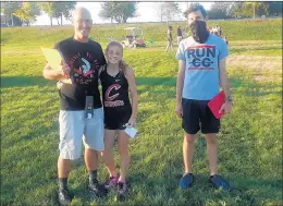  ?? STEVE MILLAR/DAILY SOUTHTOWN ?? Lincoln-WayWest’s Matt Bowden, left, coached against his daughter Nadia, a Lincoln-Way Central freshman, and former runner Ryan Stapinski, Lincoln-Way Central’s coach, during a dual meet on Oct. 6. 2020.