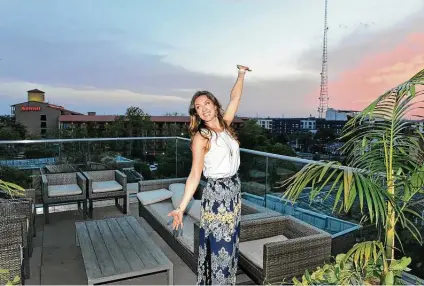  ?? Robin Jerstad / Contributo­r ?? Richele Rainosek poses at Fairmount Rooftop Oyster Bar, a popular spot for its views of downtown.