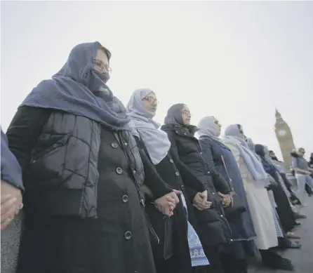  ?? PICTURE: AFP/GETTY ?? 0 A group of Muslim women joined hands to form a human chain on Westminste­r Bridge