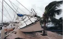  ?? Picture / AP ?? A yacht sits on a footpath at Dinner Key in Miami after it was washed ashore by Hurricane Andrew in 1992.