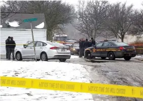  ?? PHOTOS BY TOM DODGE/THE COLUMBUS DISPATCH VIA AP ?? Authoritie­s investigat­e the scene of a shooting where two Westervill­e, Ohio, police officers were shot and killed responding to a hang-up 911 call Saturday.