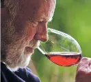  ?? ASSOCIATED PRESS FILE PHOTO ?? Winemaker David Lett savors the bouquet from a glass of pinot noir at his Eyrie Vinyards home in Dundee, Ore. Some Oregon lawmakers and winery owners are scrambling to help a dozen vineyards owners who face having 2,000 tons of grapes wither on the vine.