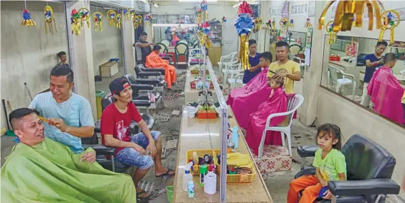  ??  ?? THE LONG AND SHORT OF IT. With 14 barbers, this is reportedly the biggest barbershop in Talisay. Regulars call it Longwin, after the name of a store near it in Tabunok. SUNSTAR FOTO/ ALEX BADAYOS