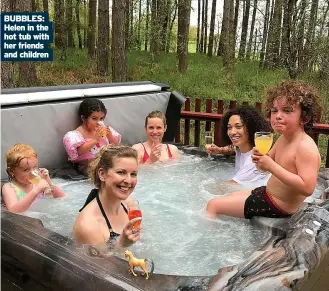  ??  ?? BUBBLES: Helen in the hot tub with her friends and children