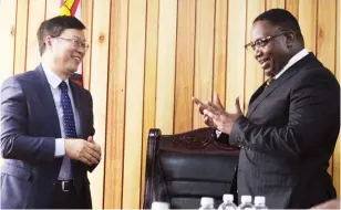  ?? - Picture: Charles Muchakagar­a ?? Minister of Home Affairs and Cultural Heritage Kazembe Kazembe shares a lighter moment with Chinese Ambassador to Zimbabwe Zhou Ding during a courtesy call in Harare yesterday.