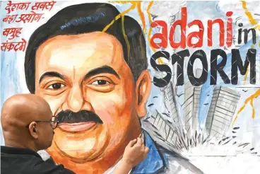  ?? (AFP) ?? Art school teacher Sagar Kambli gives final touches to a painting of Gautam Adani highlighti­ng ongoing crisis of Adani Group in Mumbai on Friday