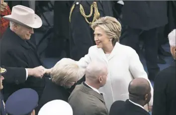  ??  ?? Hillary Clinton and former Vice President Dick Cheney, left, shake hands Friday before the start of Donald Trump’s inaugurati­on as the nation’s 45th president at the U.S. Capitol in Washington.