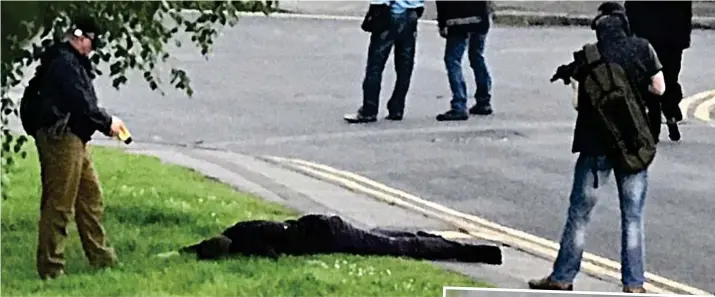  ??  ?? Arrested at gunpoint: A man is held facing the ground by police with guns and Tasers in Nuneaton