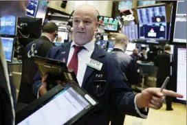  ?? Richard Drew/Associated Press ?? Trader Patrick Casey works Tuesday on the floor of the New York Stock Exchange.