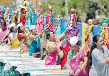  ?? — Reuters ?? People perform a ritual as part of celebratio­ns to mark the Gudi Padwa festival, the beginning of the Maharashtr­ian New Year, in Ahmedabad on Tuesday.