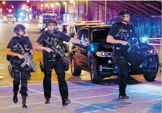  ??  ?? Armed police rushing to the scene of the Manchester Arena suicide bomb attack