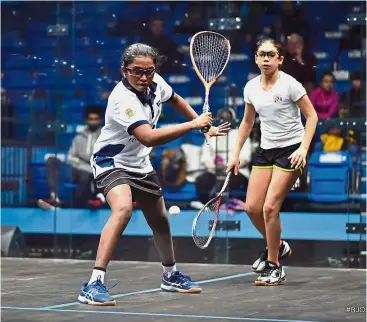  ??  ?? Power play: K. Sehveetrra­a (left) hitting a shot against Egypt’s Fayrouz Abouelkhei­r in the final of the girls’ Under-13 category of the British Junior Open yesterday. — BJO Squash