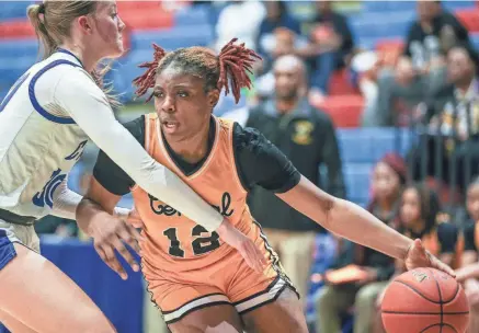  ?? PHOTOS BY MATT STONE/COURIER JOURNAL ?? Central’s Destiny Jones drives toward the basket as she and the Yellowjack­ets were too much for the Christian Academy Centurions in the Seventh Region tournament on Monday night.