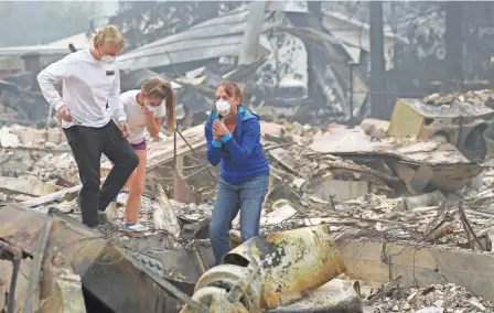  ?? JEFF CHIU, AP ?? Mary Caughey finds her wedding ring as residents sift through debris Tuesday in Kenwood, Calif.