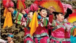 ?? ?? Performers dance on stage at a local fair in Beijing in China to mark the New Year celebratio­ns.