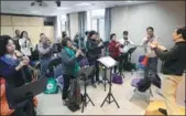  ?? LIU YING / XINHUA ?? Students learn to play the or cucurbit flute, at a university for the elderly in Shanghai last year.
